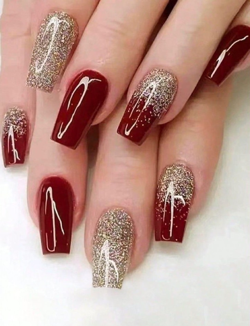 Deep red nails with gold glitter and drip details