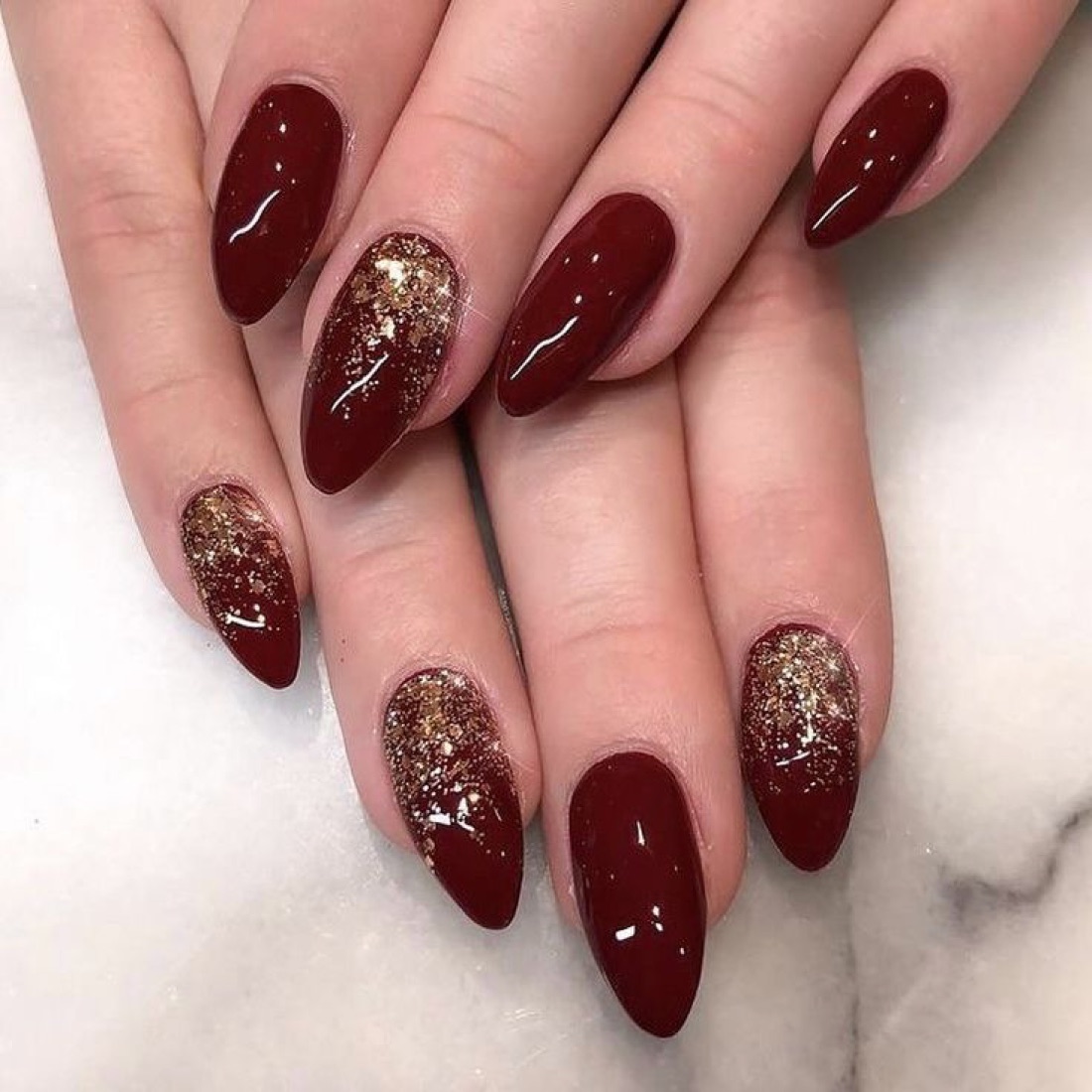 Glossy burgundy nails with glitter accent nails