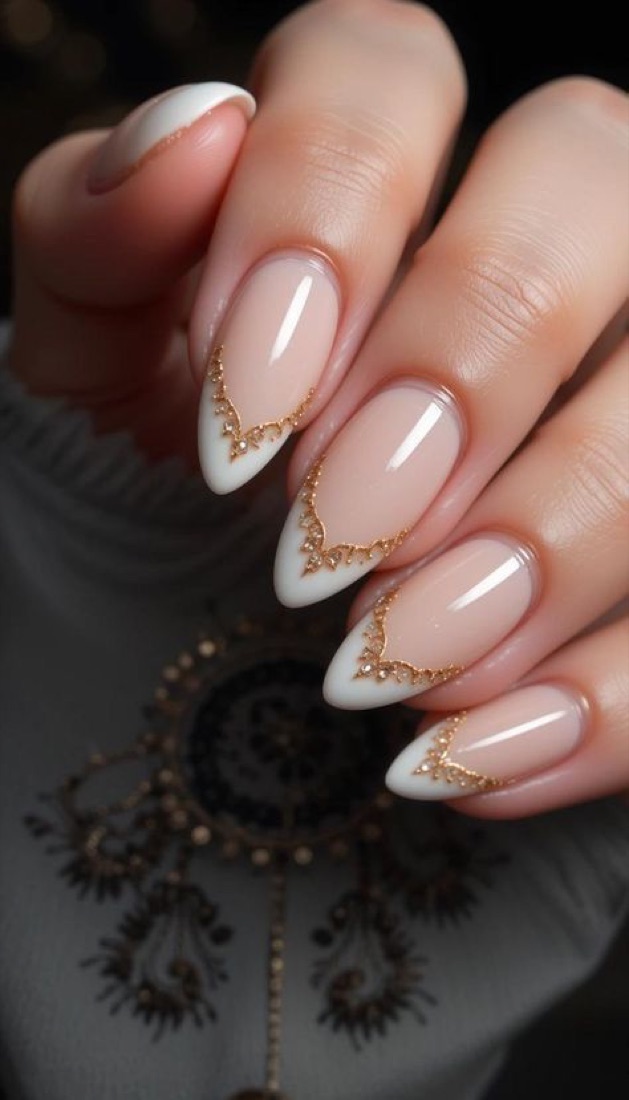 White V-shaped French tips outlined in gold